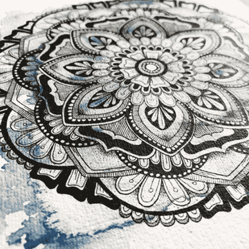 Close up of Winter mandala design with blue colour background designed by Aimee Fergusson